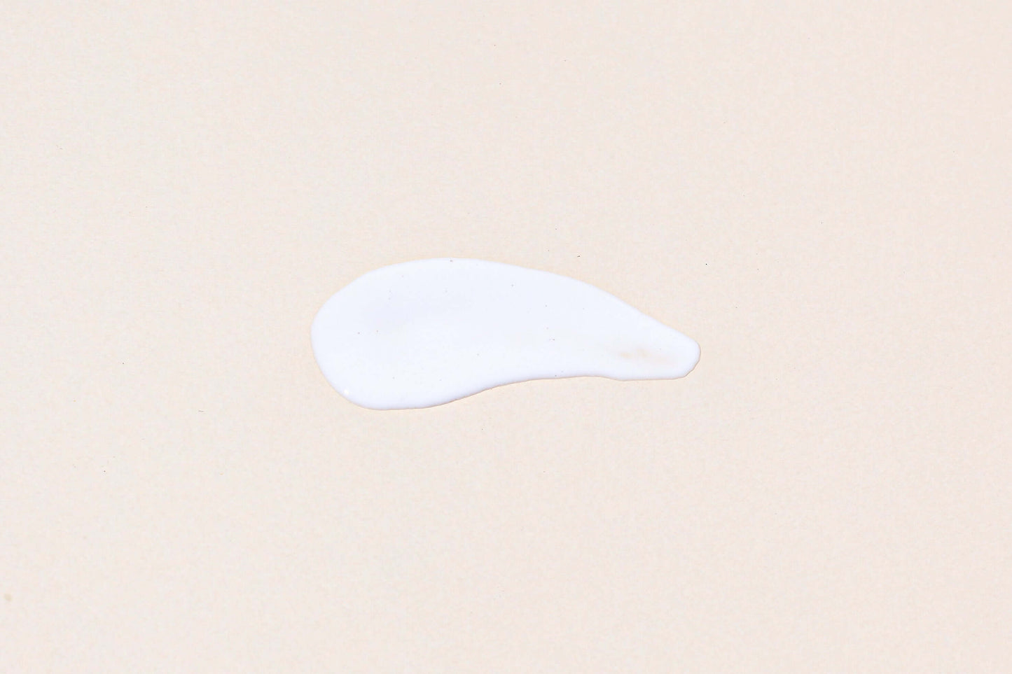 IN YOUR HEART Triple Essence Milk Cleanser creamy texture sample on a neutral background.