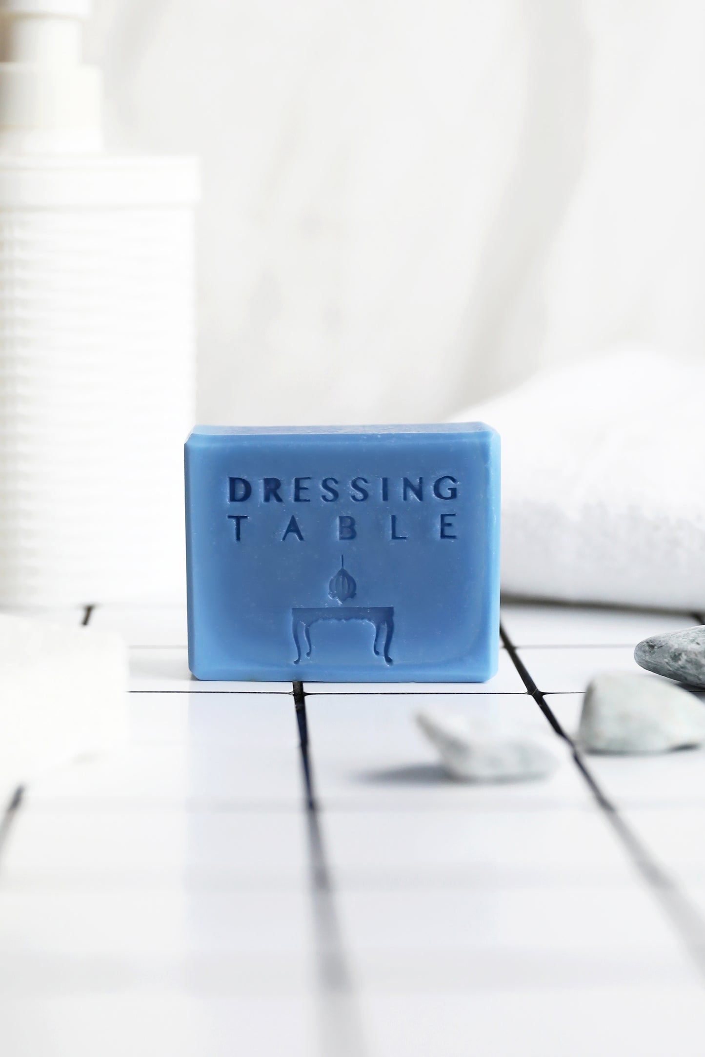 DRESSINGTABLE Indigo Calming Soap bar on a tiled surface with decor elements.
