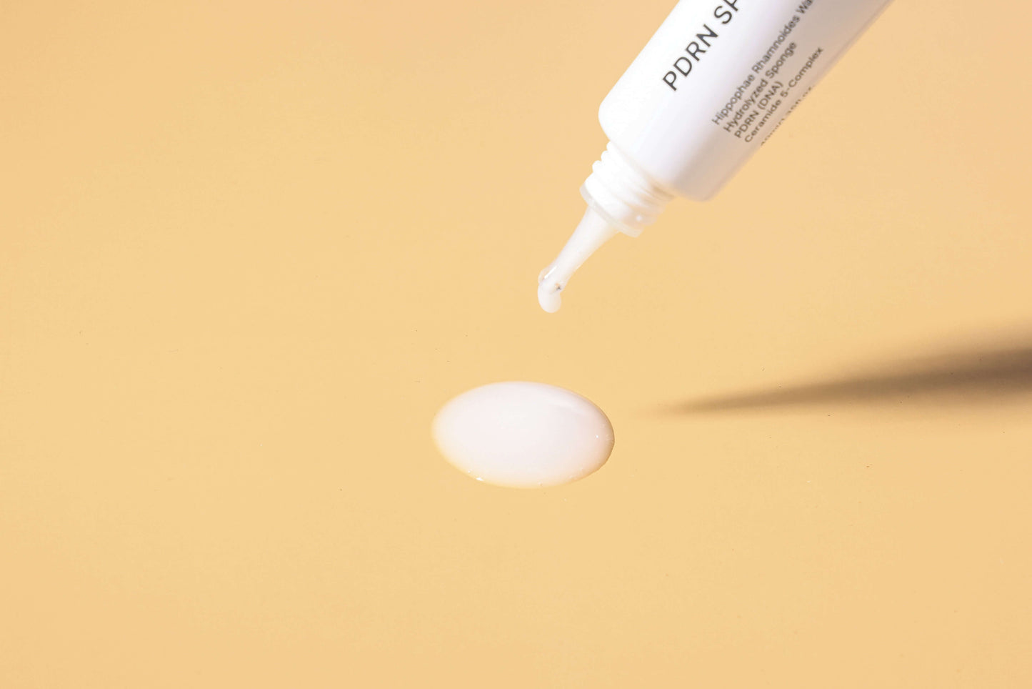 IN YOUR HEART PDRN Spicule Ampoule & Calming Care Cream Duo product application drop on beige background