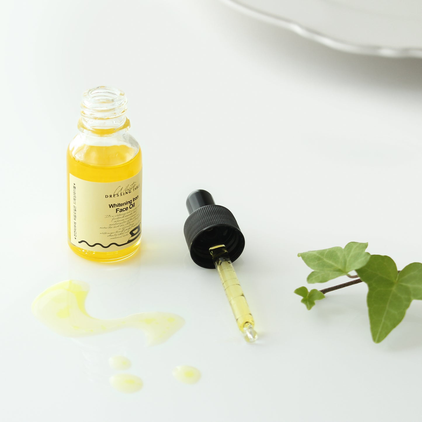 DRESSINGTABLE Brightening Iron Face Oil bottle with dropper on a white background, showcasing the lightweight formula.