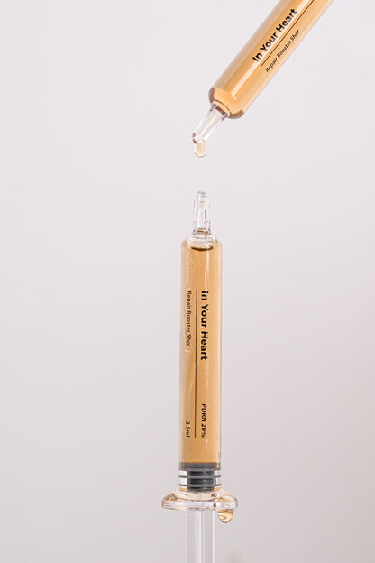 IN YOUR HEART Repair Booster Shot in a dropper and ampoule emphasizing skin rejuvenation.