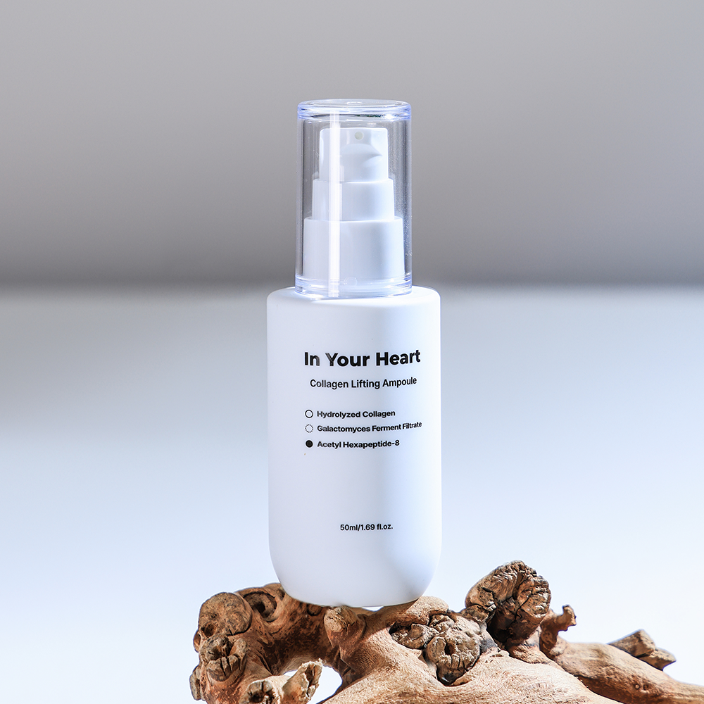 A single bottle of In Your Heart Collagen Lifting Ampoule placed on a piece of natural wood.