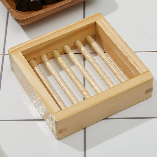 Erigeron Bath Soap Holder made with bamboo on white bath tiles.