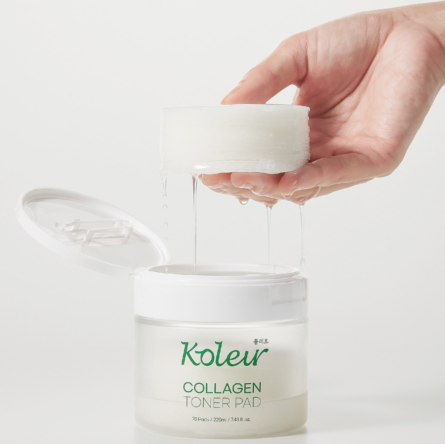 Koleur Collagen Toner Pad jar opened with a hand holding a fully soaked toner pad, showcasing the rich essence and soft cotton texture.
