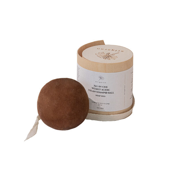 Cacao shampoo ball in brown with wooden package next to it.