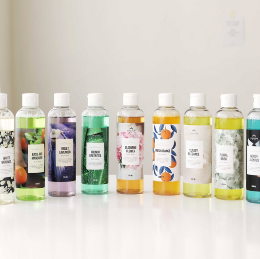 bottles of body wash in different colored liquids in a row