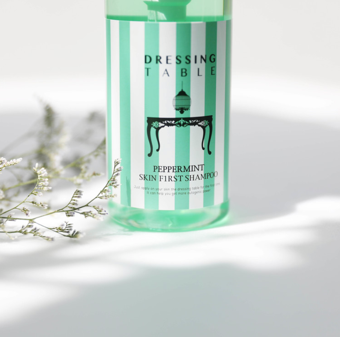 bottle of peppermint shampoo in mint green