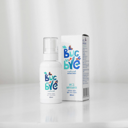 A clean, minimalistic shot of the Bug Vi Bye Spray on a white surface, positioned alongside its box. The soft lighting enhances the modern design of the product, underlining its premium, family-safe appeal.