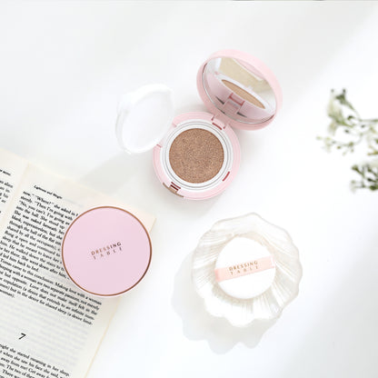 two pink foundation cushions with puff and book